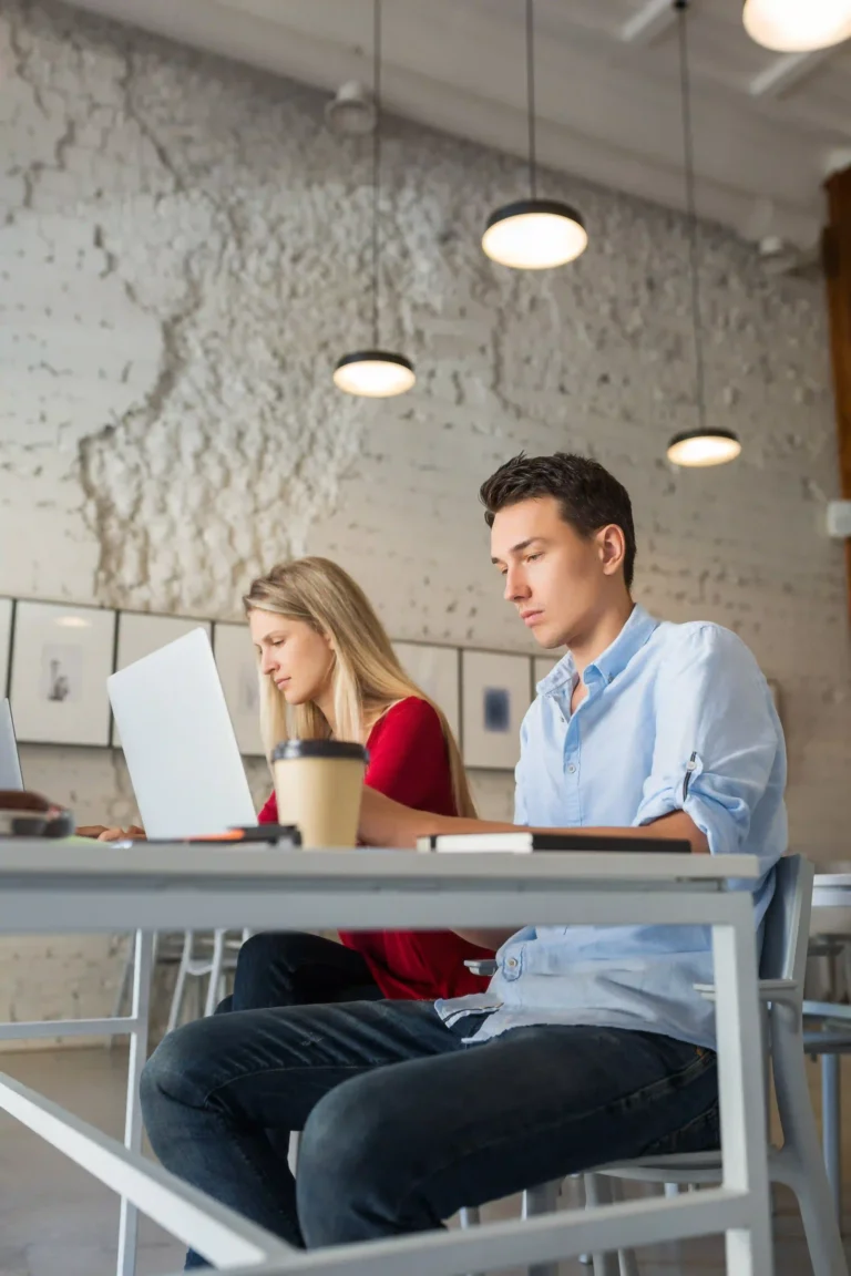 young-man-woman-working-laptop-open-space-co-working-office-room